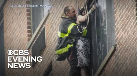 nyc firefighter saves woman trapped on ledge outside burning apartment youtube