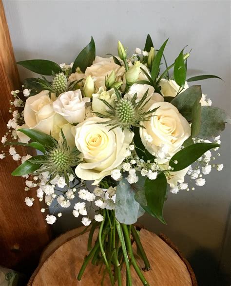 bouquet with white thistle roses lisianthus and gypsophila thistle bouquet gypsophila white