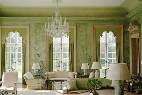 A Living Room With Green Walls And Chandelier