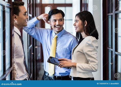 Co Workers In Office Hallway Talk About Project Stock Photo Image Of