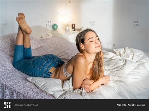 Sensual Woman Lying On Bed Stock Photo OFFSET