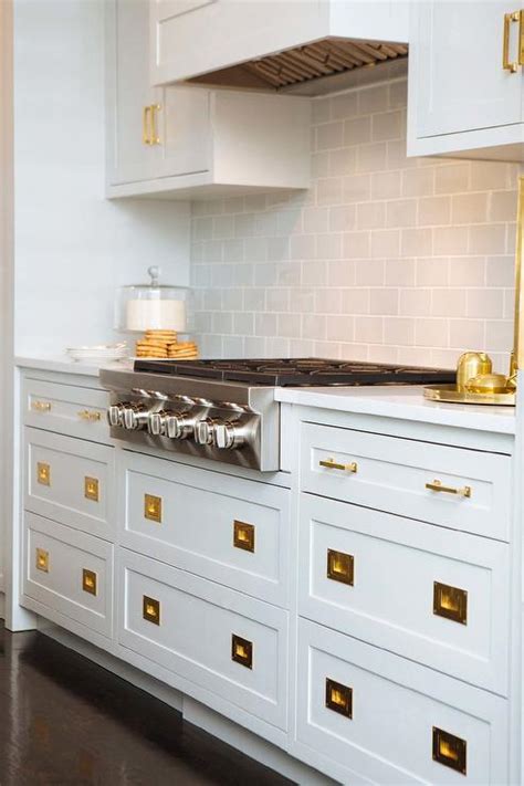 They are a type of framed cabinet where doors and drawer fronts are inset, they sit inside the door opening. White Kitchen Cabinets With Brass Hardware Design Ideas