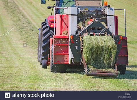 Tractor baling hay in field Stock Photo, Royalty Free Image: 76378345 ...