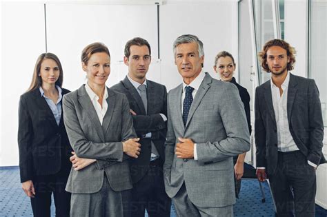 Group Of Business People Standing In Office Looking At Camera Stock Photo