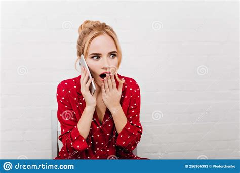 Shocked Girl In Red Night Suit Talking On Phone Indoor Portrait Of Glamorous Blonde Woman