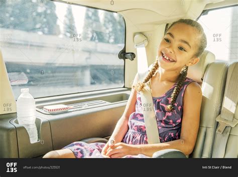 Girl Smiling In Back Seat Of Car Stock Photo Offset