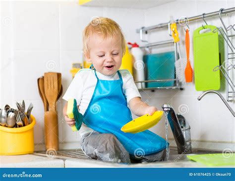 Kid Boy Washing Dishes And Having Fun In The Stock Image Image Of