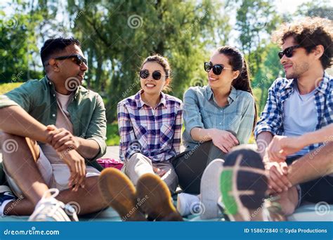 Friends Hanging Out And Talking Outdoors In Summer Stock Photo Image