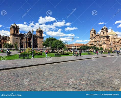 Several Tourists Admire The View Of Plaza De Armas In Beautiful And