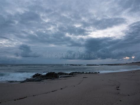 Dusk On The Rocky Beach With Dark Gray Cloudy Sky Stock Photo Image