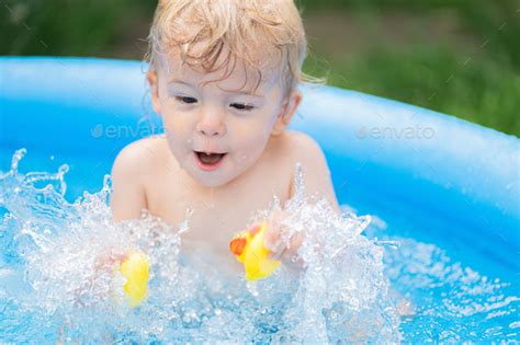 Little Happy Baby Boy Bathing In Swimming Pool At Summer Stock Photo By