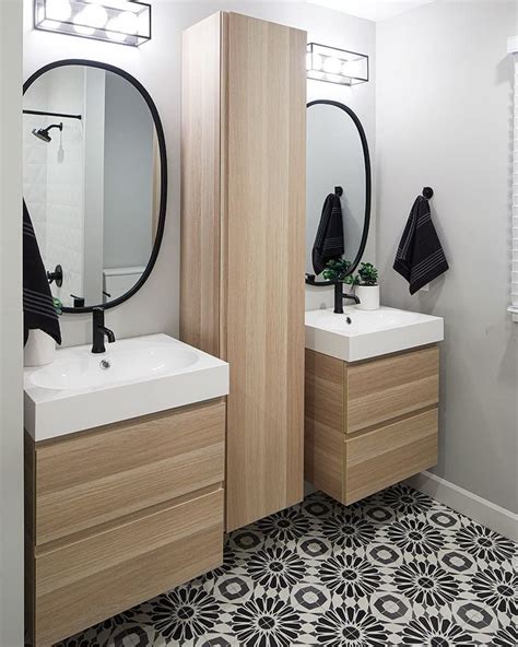 A Bathroom With Two Sinks Mirrors And Black And White Floor Tiles On