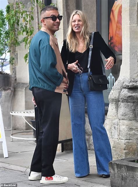 Kate Moss Enjoys A Cigarette And Bumps Into David Furnish In London