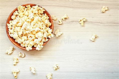 Salt Popcorn In The Wooden Bowl On The Wooden Table Stock Photo