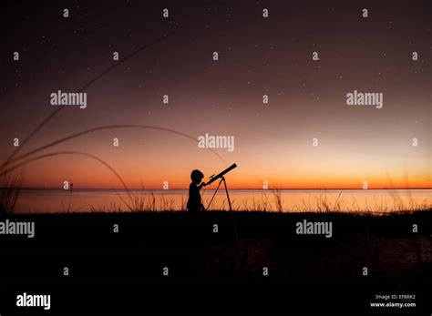 Silhouette Of Boy Looking At Stars Through Telescope Stock Photo Alamy