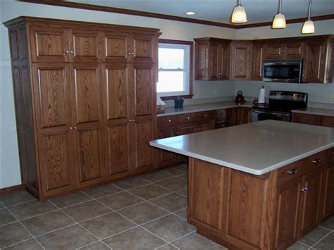 The small round island matches the cabinets throughout the kitchen. Album: Kitchen Cabinets