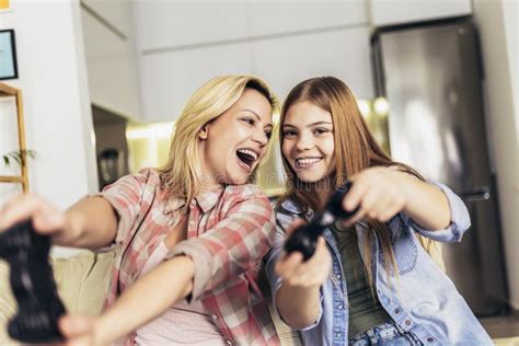 Mother And Daughter Playing Video Games Together Stock Photo Image