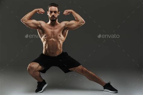 Portrait Of A Fit Muscular Bodybuilder Flexing Biceps Biceps
