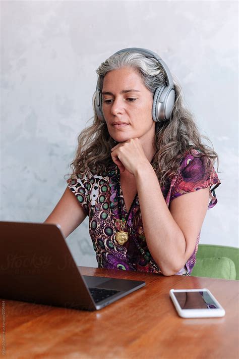 Grey Hair Natural Style Woman Are Listening Music By Viktor Solomin