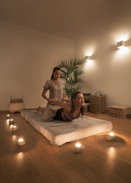 Two Women In A Room With Candles On The Floor