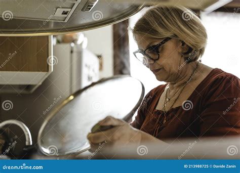 Senior Woman Cooking Lunch In The Kitchen Mature Woman In The Kitchen