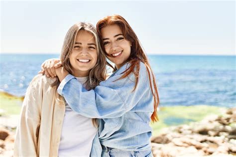 Young Lesbian Couple Of Two Women In Love At The Beach Stock Image