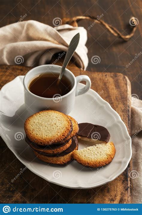 Chocolate Cookies On Plate With Cup Of Tea On Rustic Background Stock