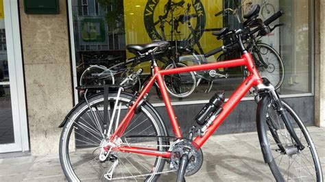 A Red Bicycle Parked In Front Of A Store