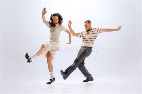 rhythm and expression energetic dance couple in retro style outfits dancing lindy hop jive on