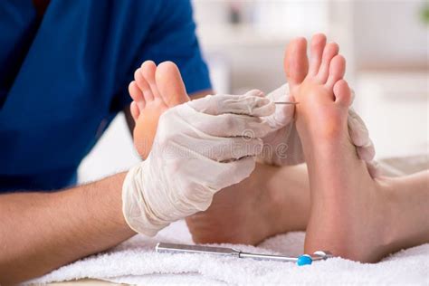 The Podiatrist Treating Feet During Procedure Stock Photo Image Of