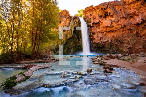 Waterfall Over A Red Rock Cliff — Photo — Lightstock