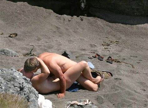 couple caught having sex on public beach photo