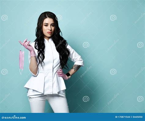 Young Beautiful Brunette Woman Doctor Or Nurse In Stylish White Costume