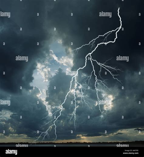 Lightning Streaks Across Stormy Cloudy Sky Just Before Sunset Stock