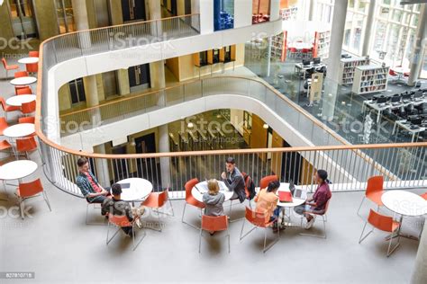 High Angle View Of Modern College Interior Students Sitting Around 