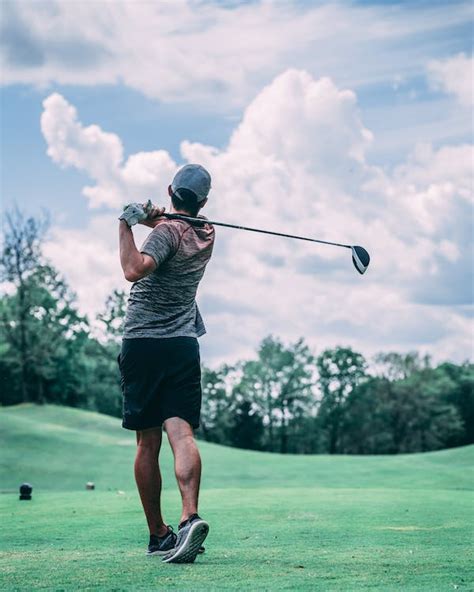 Unrecognizable Golfer With Golf Club Playing In Field Under Sky · Free