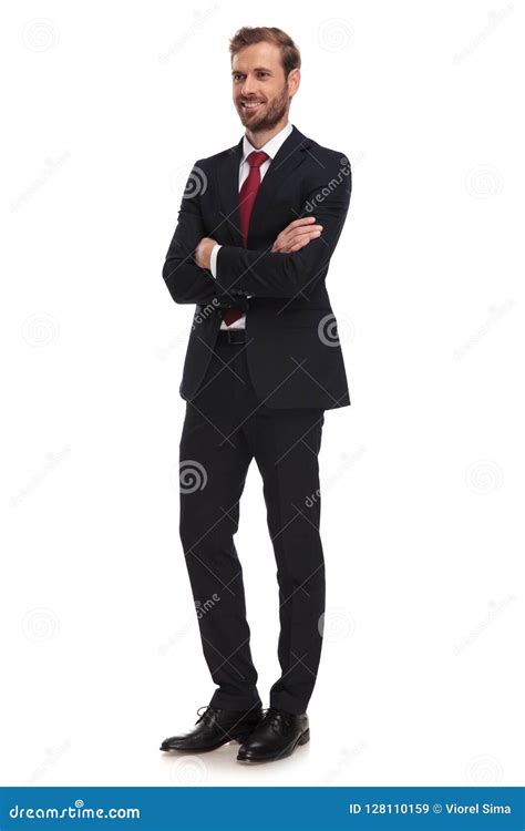 Attractive Businessman Standing With Arms Crossed Looks To Side Stock