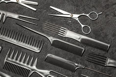 Black Combs And Combs With Scissors On A Black Background Stock Photo