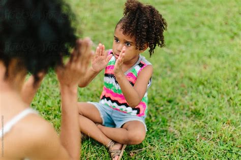 Mother And Daughter Playing Patty Cake In The Park By Stocksy Contributor Kristen Curette