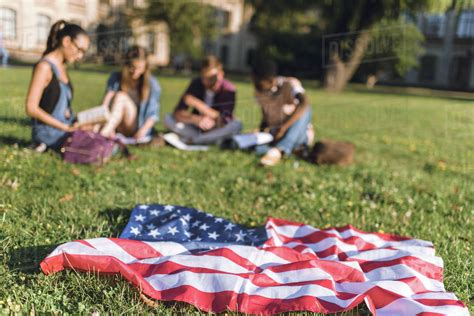 Selective Focus Of American Flag And Multiethnic Group Of Students On