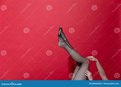 Slender Beautiful Womenand X27s Legs On A Red Background Stock Image