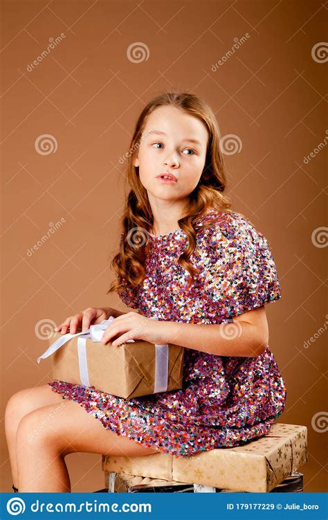 Cute Long Haired Girl Sitting With A T In Her Hands Stock Image
