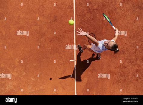 Top view of a professional female tennis player serves the tennis ball