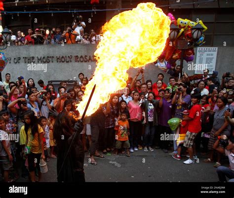 A Performer Breaths Fire During A Dragon Dance Performance In