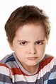 Angry kid. Close-up portrait of angry little boy isolated on white ...