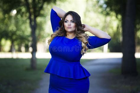 Young Beautiful Stylish Plus Size Fashion Model In Blue Dress Outdoors