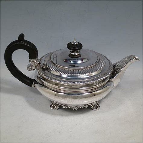 An Antique Georgian Sterling Silver Teapot Having A Plain Round