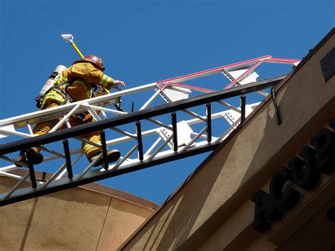 Firefighter Climbing Ladder Photograph By Jeff Lowe Pixels