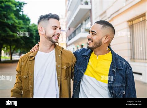Portrait Of Happy Gay Couple Spending Time Together While Walking In The Street Lgbt And Love