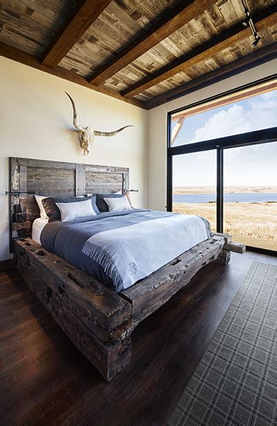 There is just something about the look of authentic barn wood that cannot be recreated with other materials. Rustic king bed frame, barn wood head board, antlers ...